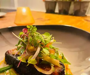 Seafood dish with salad topping. 
