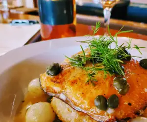 seafood entree with capers over served over gnocchi